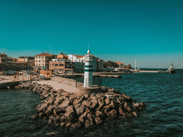 a lighthouse in the middle of a body of water, street of teal stone, lisbon, landscape photo, thumbnail