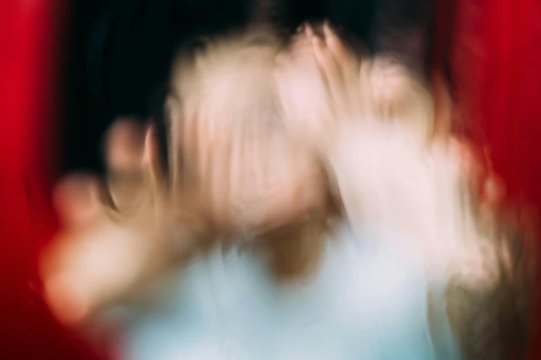 a blurry photo of a person with their hands in the air, by Jan Rustem, unsplash, abstract expressionism, woman crying, touching heads, 2010s, trapped egos in physical reality