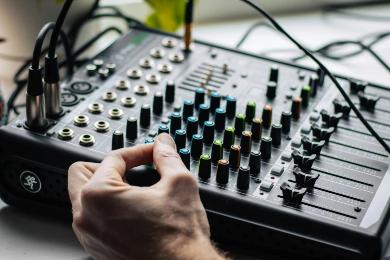 a close up of a person using a mixer, trending on pexels, circuit bent synthesis, avatar image, table with microphones, environmental shot