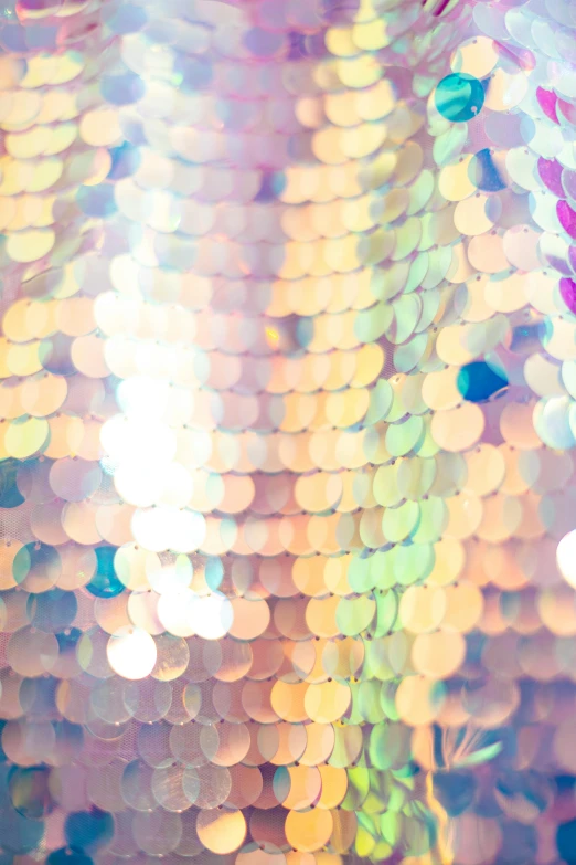 a close up of a disco ball with lights in the background, by Sophie Pemberton, holography, pastel clothing, fish scales, gold, pale pastel colours