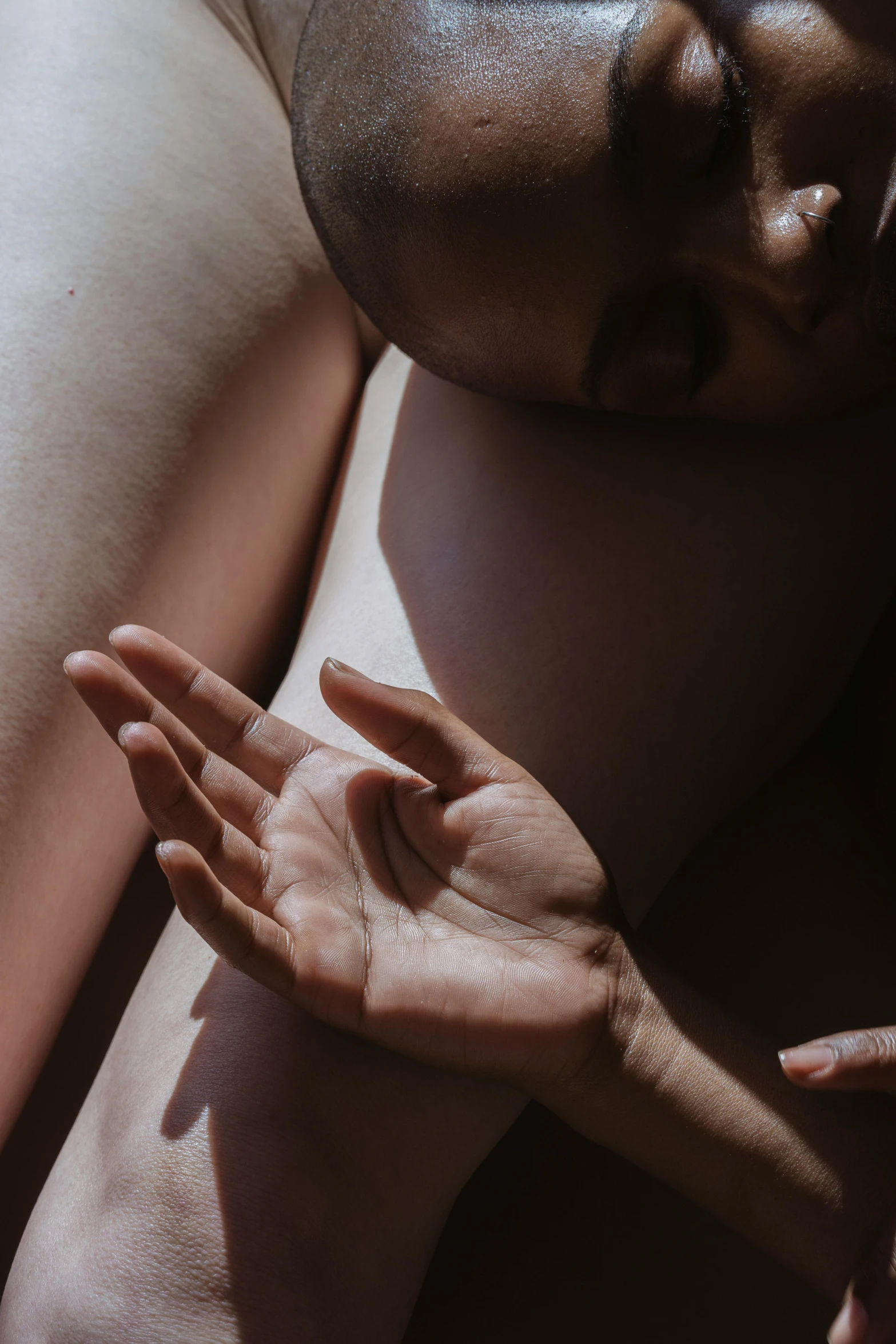 a close up of a person laying on a bed, by Elsa Bleda, trending on unsplash, massurrealism, holding each other hands, silicone skin, maternity feeling, in the sun