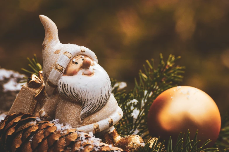 a gnome figurine sitting on top of a christmas tree, pexels contest winner, baroque, relaxed. gold background, thumbnail, bushy white beard, fossil ornaments