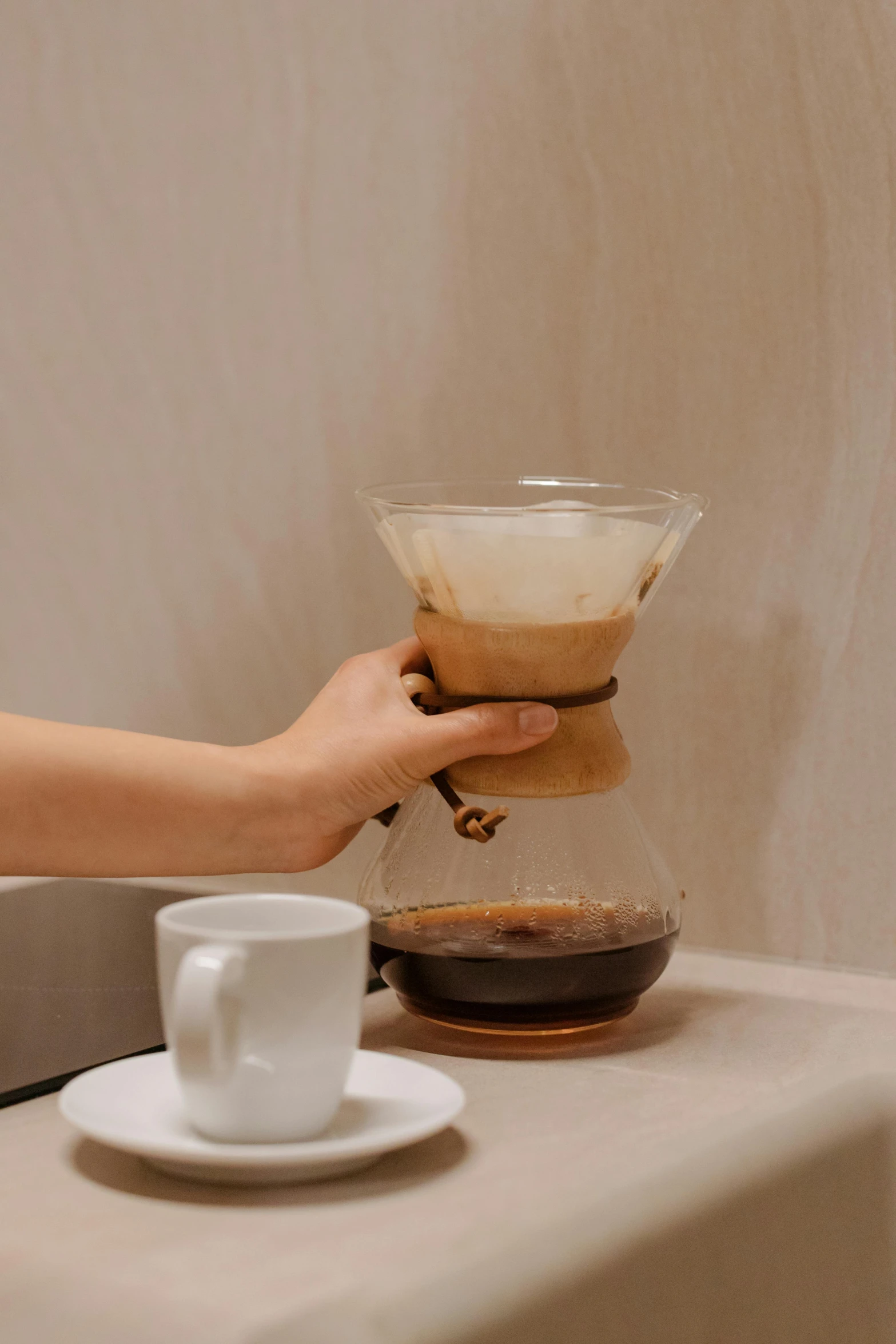 a person pours coffee into a coffee pot, by Julia Pishtar, jakarta, detailed product image, vine, basic