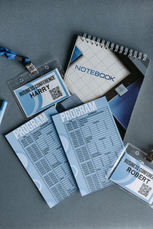 a laptop computer sitting on top of a table, labels, blue themed, notebook, ticket