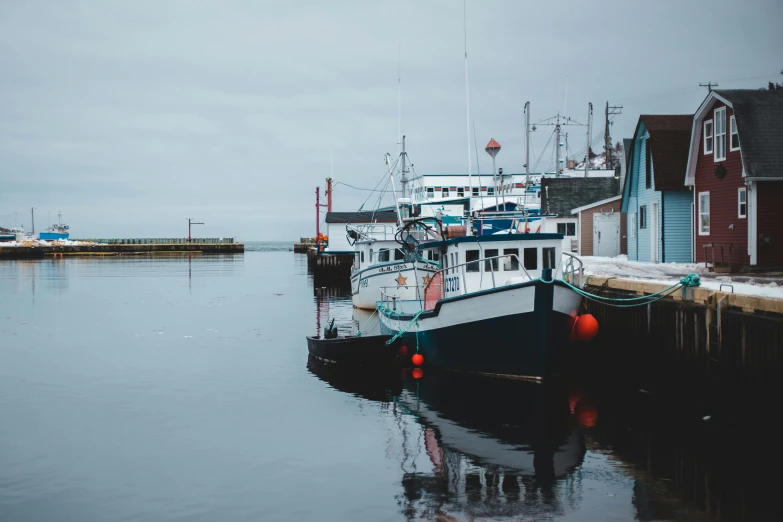 a couple of boats that are sitting in the water, by Carey Morris, pexels contest winner, fishing town, grey, hziulquoigmnzhah, background image