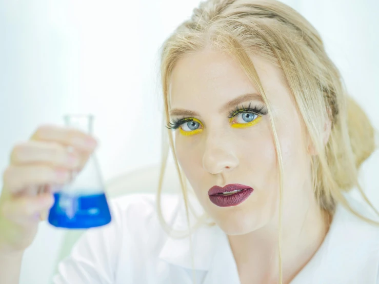 a woman in a lab coat holding a flask, a portrait, by Julia Pishtar, shutterstock, blond hair blue eyes, in professional makeup, avatar image, trending photo