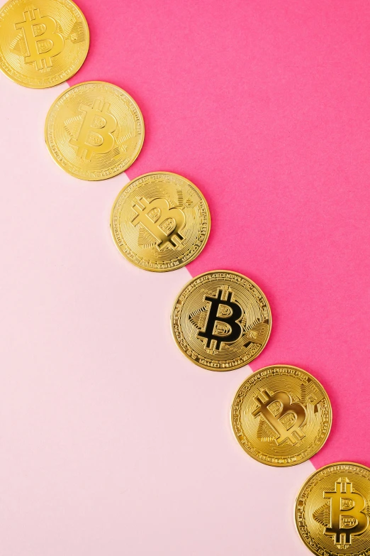 a line of golden bitcoins on a pink background, by Julia Pishtar, trending on unsplash, brightly colored, 27