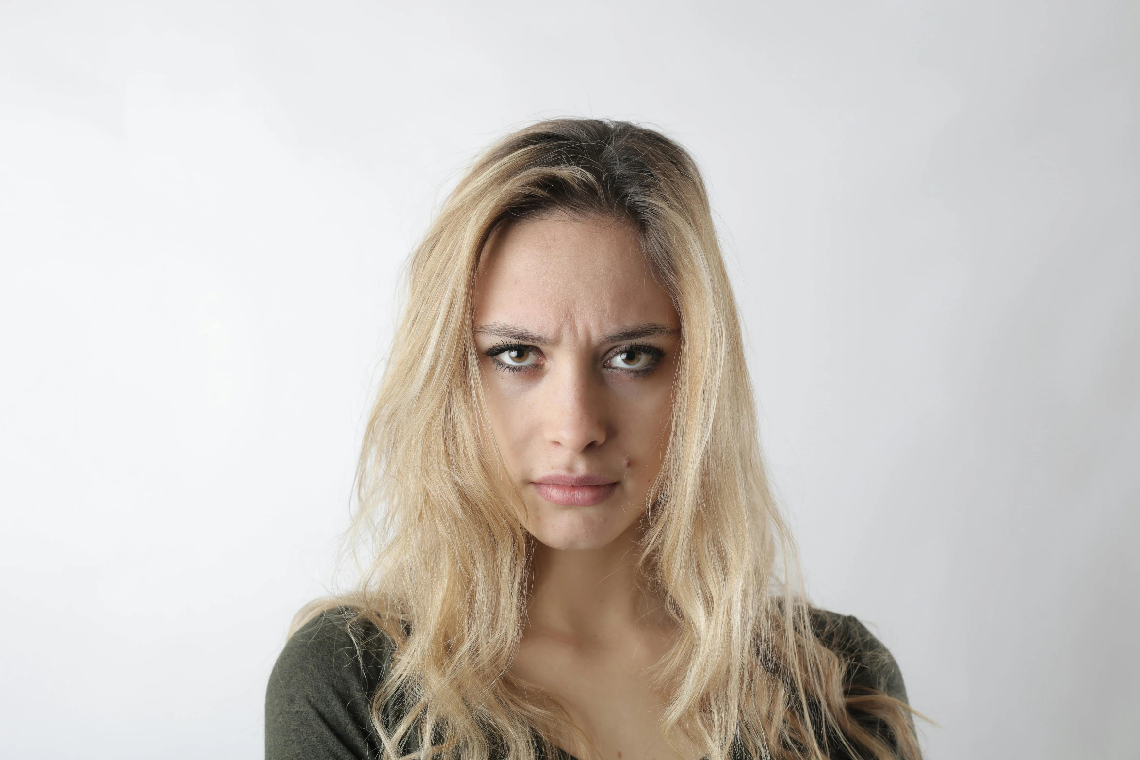 a woman with a concerned look on her face, crazy hate face, square face, blonde woman, portrait image