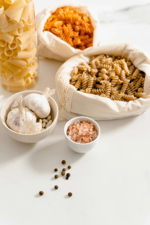 a table topped with different types of pasta, renaissance, detailed product image, pouches, salt, detail shot