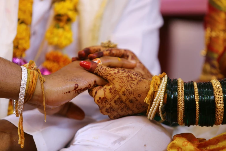 a close up of a person putting a ring on another person's hand, samikshavad, square, thumbnail, ornately dressed, yellow
