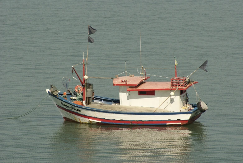 a small boat floating on top of a body of water, fishing, near the sea, on display, moored
