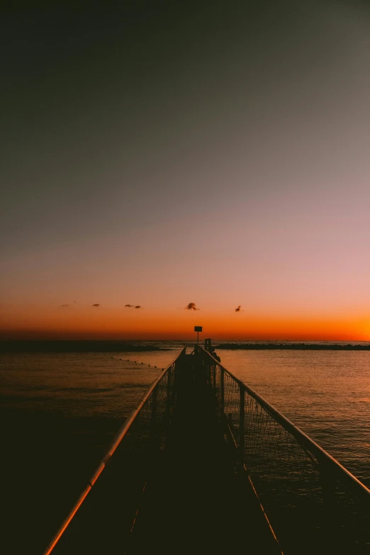 a pier that is next to a body of water, unsplash, romanticism, ((sunset)), manly, low detailed, infinite