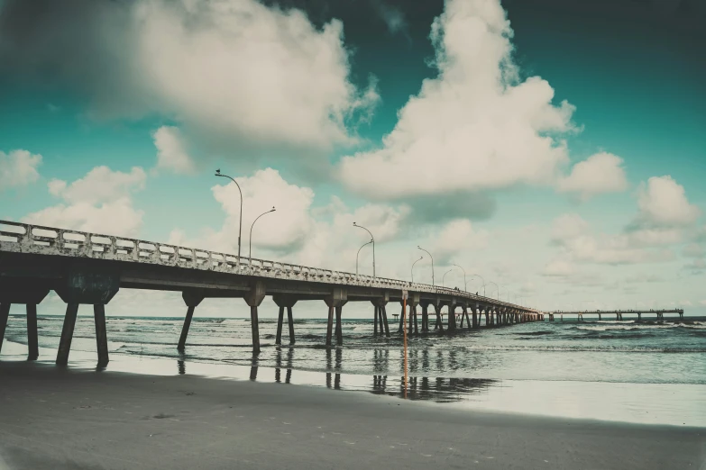 a pier sitting on top of a sandy beach, by Lucia Peka, unsplash contest winner, art photography, in retro colors, sky bridge, highly polished, hd photography street