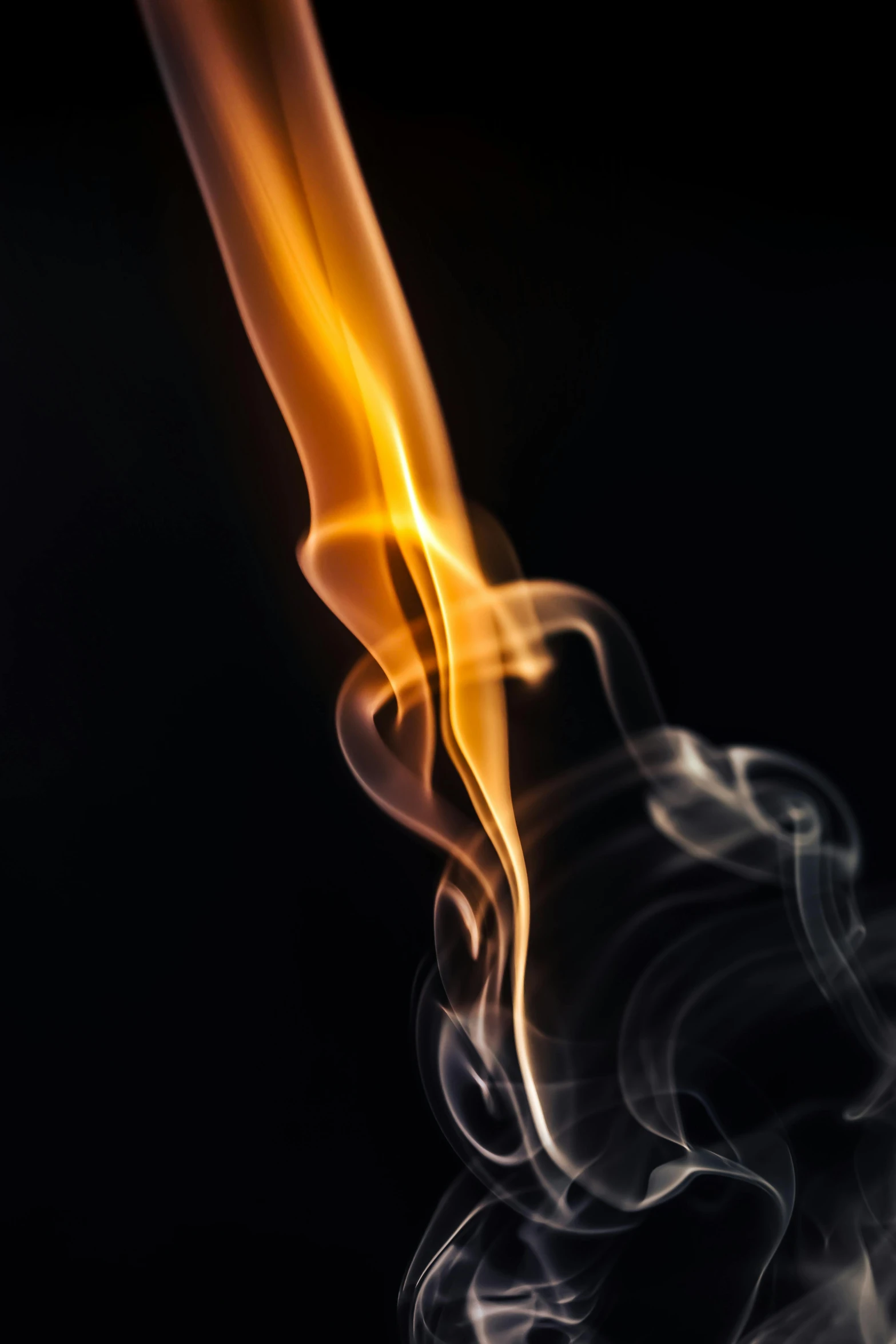 a close up of smoke on a black background, by Matt Cavotta, pexels, bathed in the the glow of a fire, on a gray background, new mexico, liquid gold