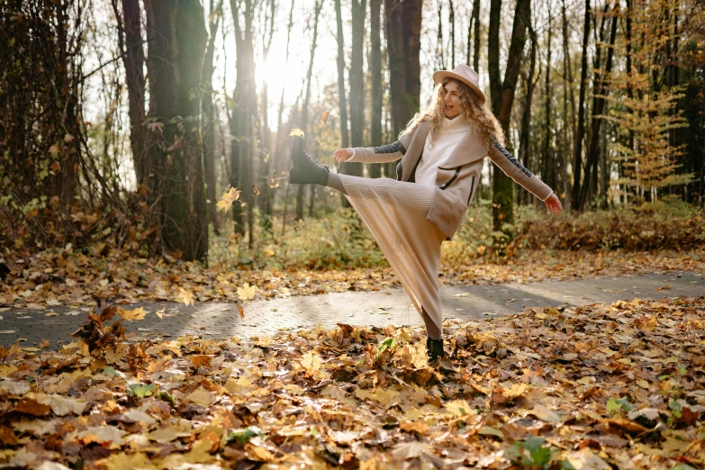 a woman that is standing in the leaves, pexels, arabesque, dynamic dancing pose, beige, autumnal, 15081959 21121991 01012000 4k