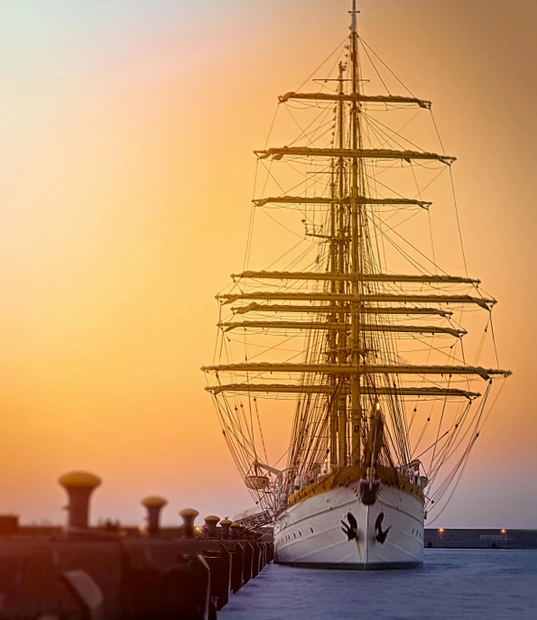 a tall ship sitting on top of a body of water, a tilt shift photo, pexels contest winner, romanticism, golden hour”, white, navy, alexey egorov