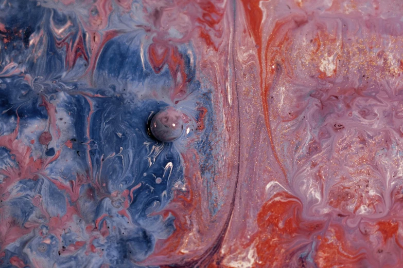 a close up of a red and blue object, inspired by Shōzō Shimamoto, unsplash contest winner, space art, venus surface, made of liquid, muted blue and red tones, muddy colors