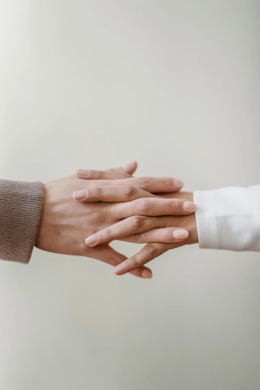 a close up of two people shaking hands, by Francis Helps, healing, on grey background, lightly dressed, concern