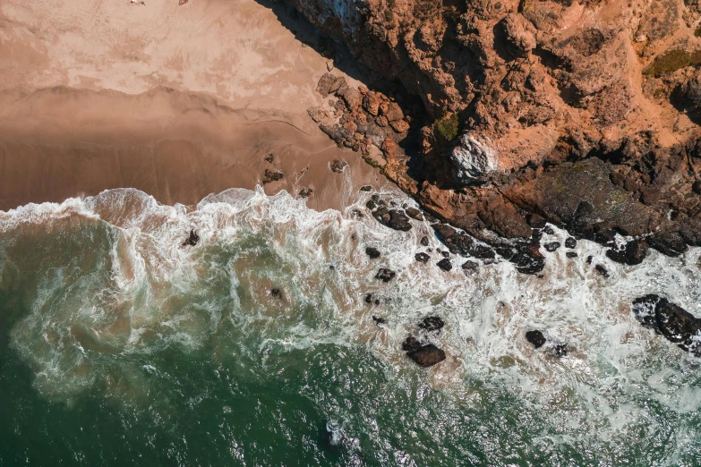 a group of people standing on top of a beach next to the ocean, pexels contest winner, “ aerial view of a mountain, waves crashing at rocks, “ iron bark, high detail 4k