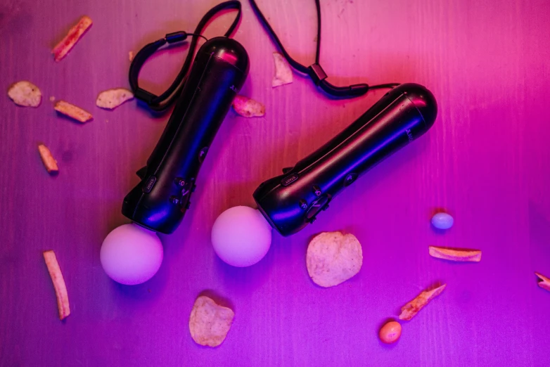 a couple of remotes sitting on top of a table, by Julia Pishtar, balls of light for eyes, clubs, hololive, studio photo