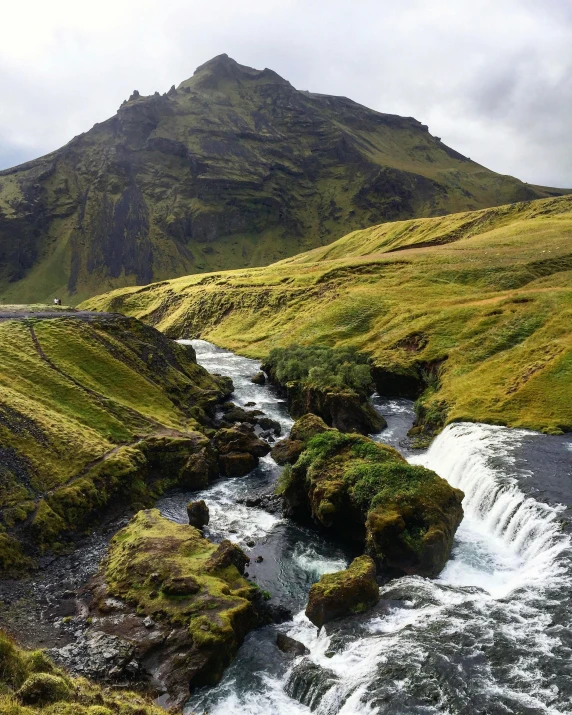 a river running through a lush green valley, by Hallsteinn Sigurðsson, giant imposing mountain, popular on instagram, & a river, cascading