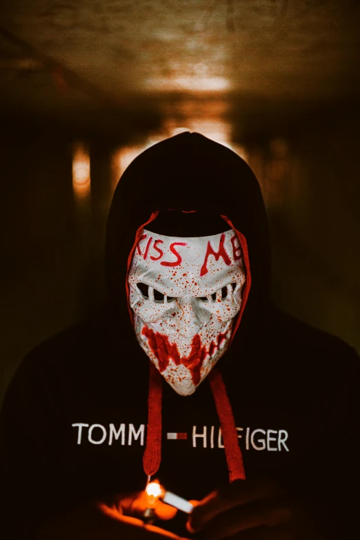 a person wearing a mask holding a cell phone, an album cover, by Thomas Bock, tumblr, the grim reapper, connor hibbs, kiss, profile image