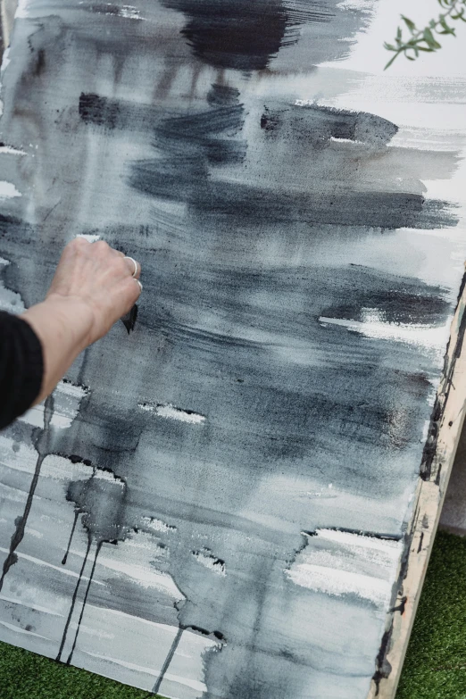 a person painting on a canvas on the grass, a detailed painting, inspired by Richter, unsplash, grey mist, black watercolour, detail texture, dark sky