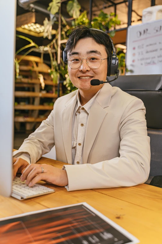 a man sitting at a desk in front of a computer, inspired by Jang Seung-eop, wearing headset, confident smirk, asian, wholesome