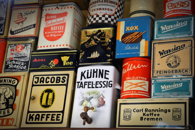 a bunch of tins are stacked on top of each other, by Daniel Lieske, pexels contest winner, maximalism, vintage european folk art, coffee, labels, 🦩🪐🐞👩🏻🦳