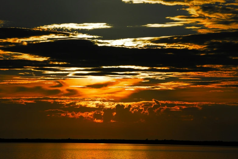 a large body of water under a cloudy sky, a picture, pexels contest winner, romanticism, dappled golden sunset, slide show, ((sunset)), phot