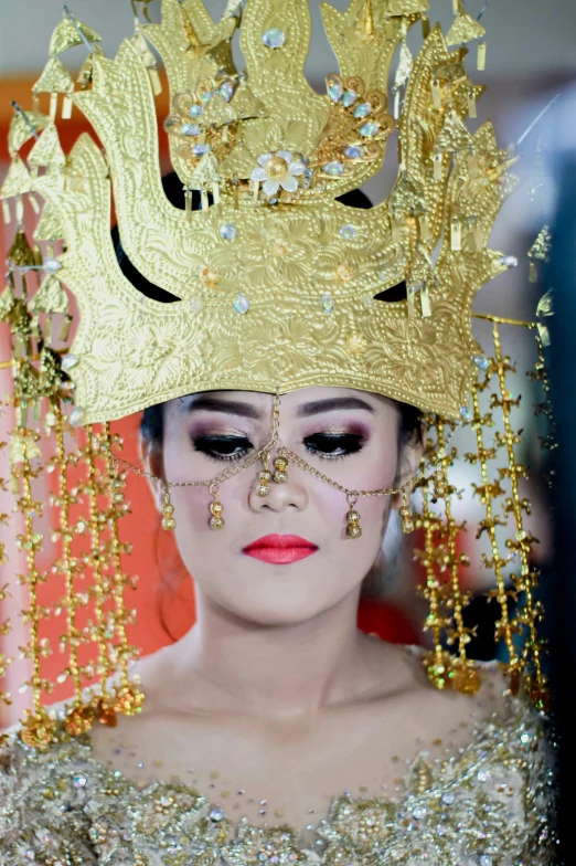 a woman with a golden crown on her head, pexels contest winner, sumatraism, huge earrings and queer make up, square, groom, slide show