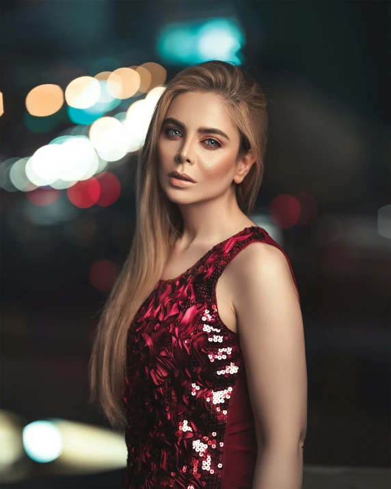a woman in a red dress posing for a picture, a colorized photo, inspired by Elsa Bleda, pexels contest winner, happening, avril lavigne, city lights in the background, elizabeth olsen, non binary model