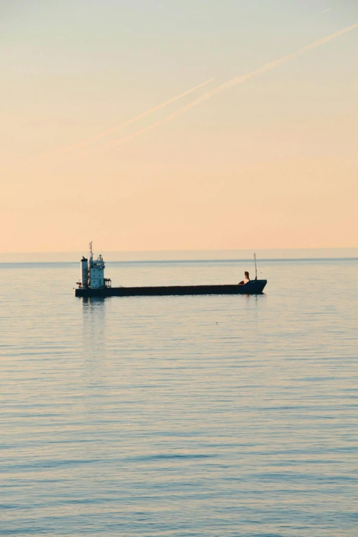 a boat in the middle of a large body of water, a picture, flickr, minimalism, utilitarian cargo ship, late summer evening, minn, a handsome