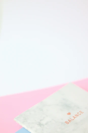 a stack of books sitting on top of a pink table, white minimalistic background, marbled, 2019 trending photo