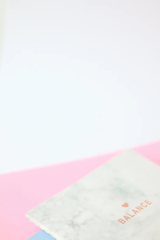 a stack of books sitting on top of a pink table, white minimalistic background, marbled, 2019 trending photo