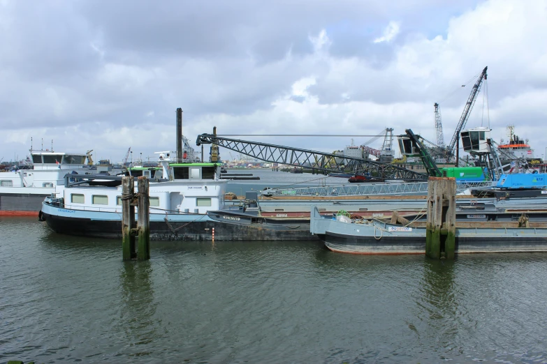 a couple of boats that are sitting in the water, a photo, inspired by August Lemmer, hurufiyya, industrial setting, various sizes, 3 boat in river, thumbnail