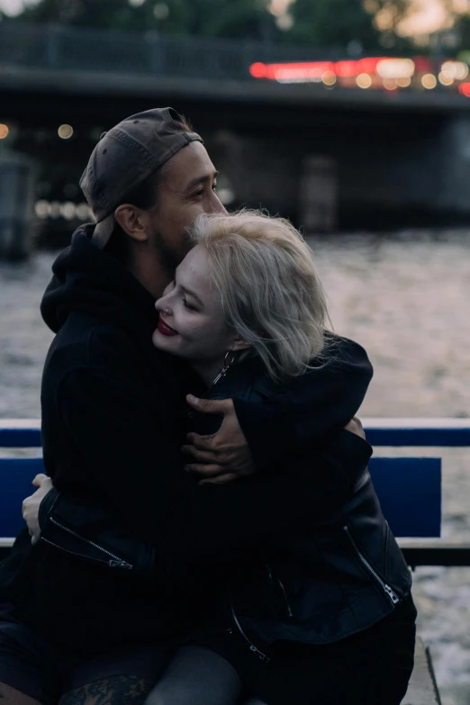 a couple of people that are sitting on a bench, pexels contest winner, romanticism, julia garner, hugging each other, on a boat, non-binary