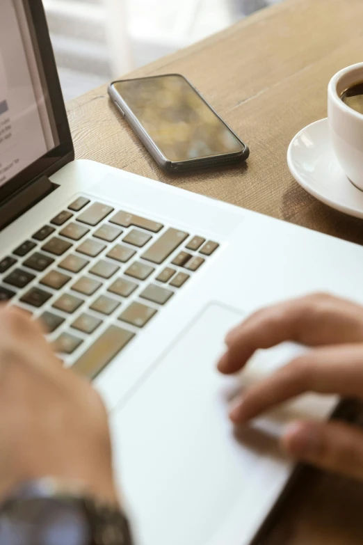 a person typing on a laptop next to a cup of coffee, multiple stories, thumbnail, blank, brown