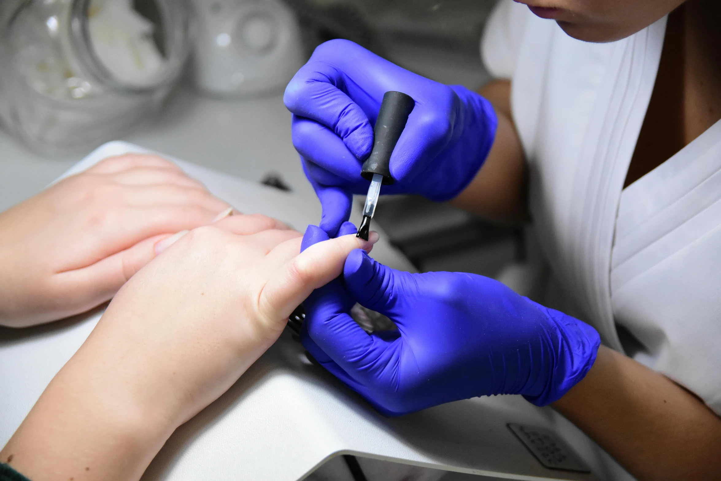 a woman getting her nails done at a nail salon, by Adam Marczyński, pexels, blue veins, surgical iv drip, thumbnail, micro detail 4k