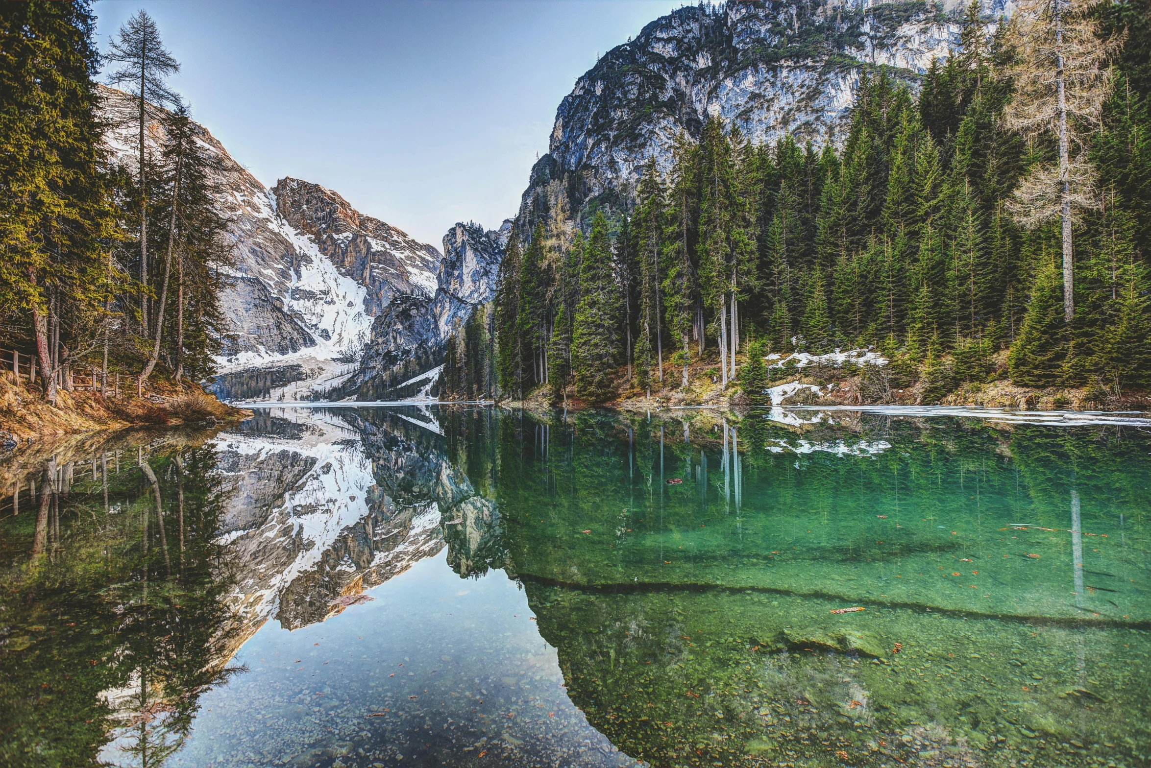 a large body of water surrounded by trees, by Sebastian Spreng, pexels contest winner, renaissance, dolomites, glossy surface, istock, conde nast traveler photo