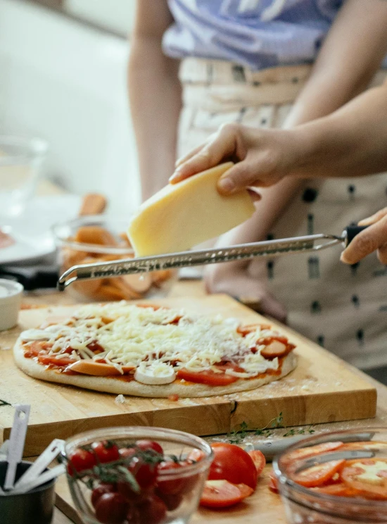 a group of people preparing a pizza in a kitchen, profile image, (cheese), fan favorite, thumbnail