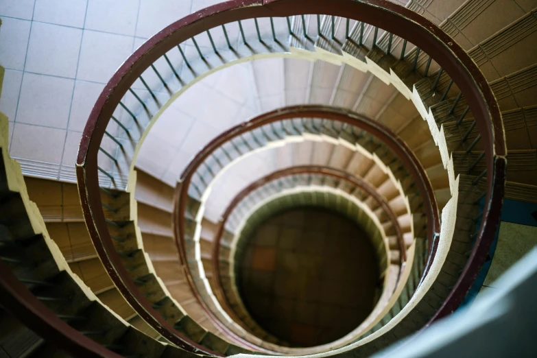 a close up of a spiral staircase in a building, an album cover, inspired by Anna Füssli, pexels contest winner, bauhaus, brown, high view, thumbnail, multiple stories
