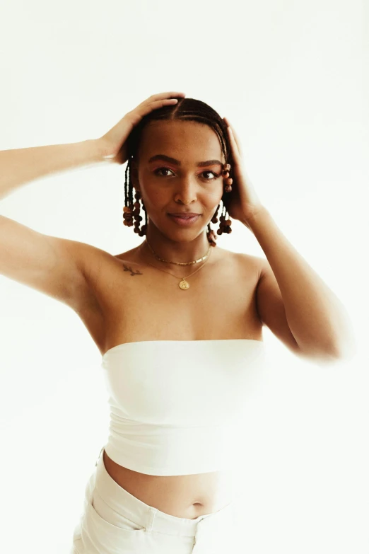a woman in a white top posing for a picture, an album cover, by Dulah Marie Evans, trending on pexels, renaissance, braids, mixed race woman, wearing bra, sydney sweeney