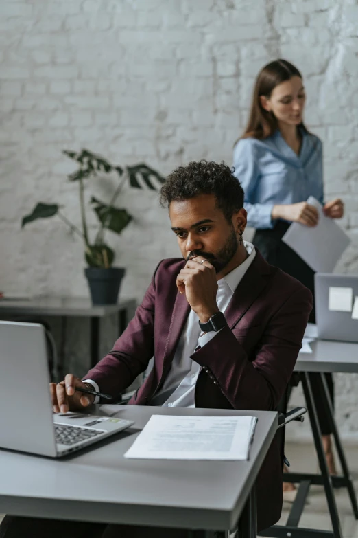 a man sitting at a desk in front of a laptop computer, pexels contest winner, varying ethnicities, two characters, serious business, trending on attestation