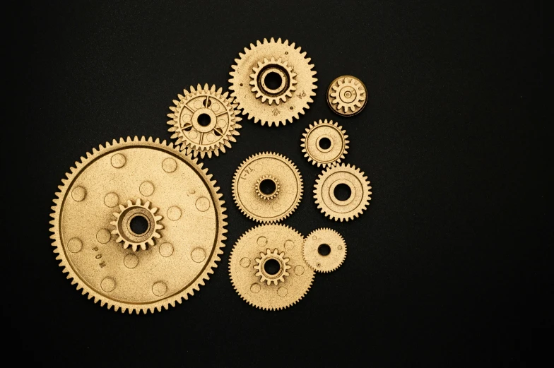 a bunch of gears sitting on top of a table, on a black background, golden organic structures, thumbnail, high quality product image”
