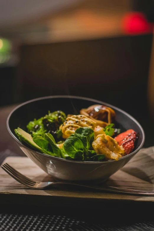 a bowl of food sitting on top of a table, lush greens, warm atmosphere, glazed, ground level shot