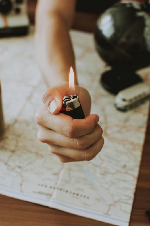 a person holding a lighter on top of a map, candle, dwell, profile image, small