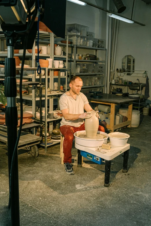 a man is making a bowl out of clay, a portrait, arbeitsrat für kunst, sitting on the porcelain throne, promotional image, demna gvasalia, production photo