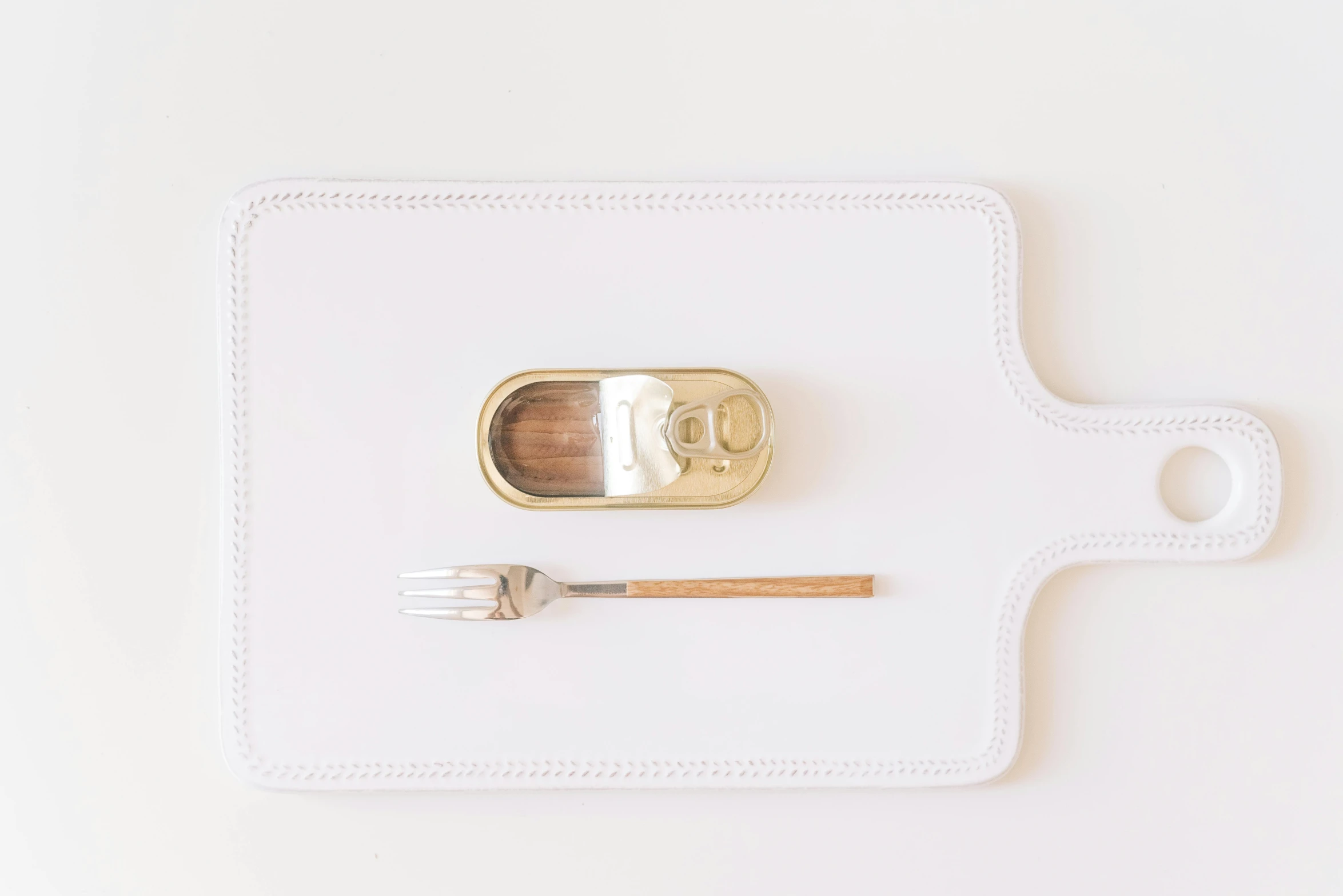 a can of tuna next to a fork and knife, by Nicolette Macnamara, white soft leather model, gold, rectangle, 3 - piece