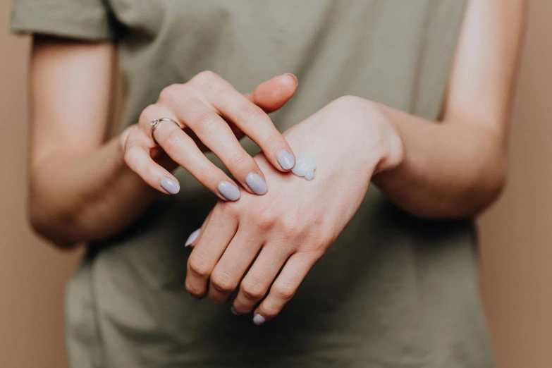 a close up of a person's hands with a lot of cream on them, trending on pexels, antipodeans, woman holding another woman, background image, moisture, holding a bottle